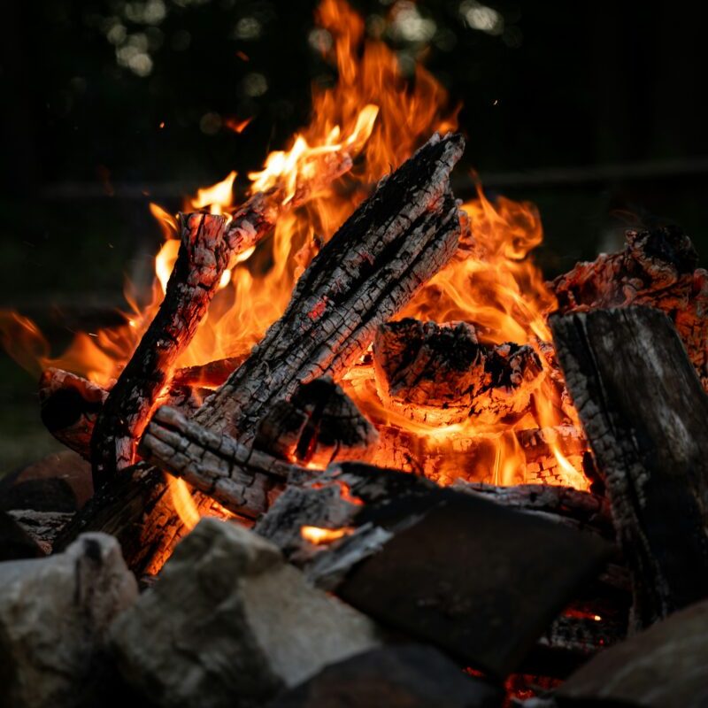 Burning logs in a campfire at night